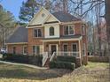 Beautiful brick home featuring a welcoming front porch and well-maintained landscaping at 1025 Shellrock Dr Dr, Wake Forest, NC 27587