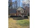 Traditional brick home boasts a well-manicured lawn and inviting front entry, surrounded by mature trees at 1025 Shellrock Dr Dr, Wake Forest, NC 27587