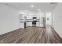 Open-concept kitchen boasts stainless appliances, granite countertops, and stylish flooring at 1115 Tofino Dr, Durham, NC 27704