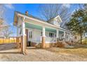 Home showcasing covered front porch supported by brick columns and inviting seating area at 1127 W Webb Ave, Burlington, NC 27217