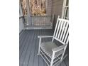 Cozy front porch with a rocking chair and a porch swing, perfect for relaxing at 113 Hawkscrest Ct, Apex, NC 27502