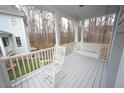 Spacious front porch with a rocking chair and swing overlooking a wooded lot at 113 Hawkscrest Ct, Apex, NC 27502