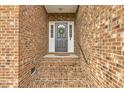 Classic front door with sidelights, decorative wreath, and brick steps leading to the entrance at 124 D'Ango Cir, Angier, NC 27501