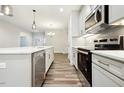 Modern kitchen with stainless steel appliances, white countertops, and a subway tile backsplash at 1794 Parham Dr, Graham, NC 27253