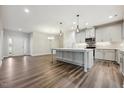 Open-concept kitchen featuring a large island, modern appliances, and pendant lighting at 1794 Parham Dr, Graham, NC 27253