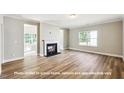 Cozy living room with fireplace, neutral color palette, and natural light at 1794 Parham Dr, Graham, NC 27253