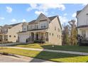 Charming two-story home features an attached two-car garage and a well-manicured front lawn at 204 Woodstaff Ave, Wake Forest, NC 27587