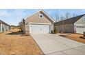 Exterior view of a charming single Gathering home and two car garage at 2109 Flycatcher Ln, Fuquay Varina, NC 27526