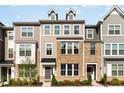 Charming townhome showcasing a brick facade and well-manicured landscaping at 234 Palmetto Tree Way, Knightdale, NC 27545