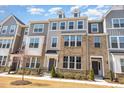 Attractive townhouse with brick and siding, accented by blooming trees and manicured landscaping at 234 Palmetto Tree Way, Knightdale, NC 27545