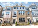 Stylish townhouse showcasing a brick facade, multiple windows, and a well-manicured front yard at 234 Palmetto Tree Way, Knightdale, NC 27545