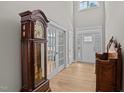 Elegant foyer featuring hardwood floors, high ceilings, a beautiful front door, and vintage decor at 290 Whistlers Cv, Louisburg, NC 27549