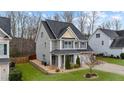 Charming two-story home with a well-manicured lawn, gray siding, and a two-car garage at 307 Sugarberry Ln, Clayton, NC 27527
