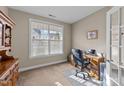 Bright office space featuring a large window, neutral walls, and classic wooden desk with an office chair at 307 Sugarberry Ln, Clayton, NC 27527
