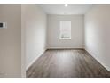 Cozy bedroom with a window letting in natural light and beautiful, dark hardwood floors at 31 Red Cedar Way, Fuquay Varina, NC 27526