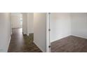 Hallway view featuring hardwood floors throughout, and white base-molding at 31 Red Cedar Way, Fuquay Varina, NC 27526
