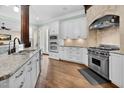 Modern kitchen with stainless steel appliances, granite countertops, and ample cabinet space at 3324 Thomas Rd, Raleigh, NC 27607