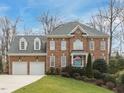 Stately brick home with attached garage and landscaped front yard at 3359 Hampton Rd, Raleigh, NC 27607
