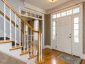 Welcoming foyer featuring hardwood floors, staircase, and a bright entry door with sidelights at 3359 Hampton Rd, Raleigh, NC 27607