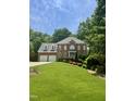 Lovely brick home with a well-maintained lawn, mature trees, and a welcoming entrance at 3359 Hampton Rd, Raleigh, NC 27607