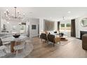 Bright open concept showcasing a modern living room connected to dining area and kitchen at 521 Providence Springs Ln, Fuquay Varina, NC 27526