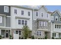 New townhomes featuring siding and stone detailing in a modern style at 607 Dorset Stream Dr, Fuquay Varina, NC 27526