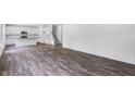 Spacious living room featuring hardwood floors and plenty of natural light with view to the kitchen at 631 Contento Ct, Sanford, NC 27330