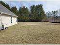 Large backyard featuring an open grassy area, perfect for outdoor activities and relaxation at 631 Natalie Dr, Graham, NC 27253