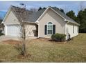 Attractive home exterior showing the attached garage and inviting front yard with simple landscaping at 631 Natalie Dr, Graham, NC 27253