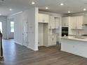 Bright kitchen featuring white cabinets, stainless appliances, and a center island at 660 Sun Meadow Dr, Wake Forest, NC 27587
