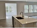 Bright kitchen featuring white cabinets, stainless appliances, and a center island at 660 Sun Meadow Dr, Wake Forest, NC 27587