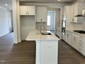 Bright kitchen featuring white cabinets, stainless appliances, and a center island at 660 Sun Meadow Dr, Wake Forest, NC 27587