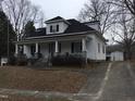 Inviting home with a covered front porch, showcasing its classic architecture and potential for outdoor living at 925 Harris St, Burlington, NC 27217