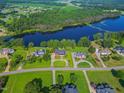 Stunning aerial view of waterfront homes surrounding a serene lake and lush green landscape at 93 Shoreline Dr, Princeton, NC 27569