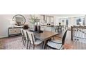 Open-concept dining area with a stylish wooden table and view into the kitchen at 10624 Pleasant Branch Dr # 7, Raleigh, NC 27614
