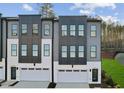 Contemporary townhome exteriors featuring two-car garages and modern architectural details at 10624 Pleasant Branch Dr # 7, Raleigh, NC 27614