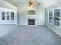 Bright living room with a fireplace and large windows offering plenty of natural light at 1125 Field Meadows Dr, Zebulon, NC 27597