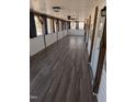 Long hallway featuring wood floors, ceiling lights, windows and light-colored walls at 122 Tomahawk Dr, Louisburg, NC 27549