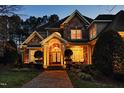 Attractive two-story home showcasing a combination of stone and brick facade, enhanced by a well-maintained lawn and inviting porch at 12417 Richmond Run Dr, Raleigh, NC 27614