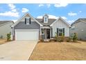 Attractive home featuring a two-car garage, brick accents, and inviting curb appeal at 133 Alumroot Road Rd, Holly Springs, NC 27540