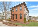 Two-story brick home, showcasing manicured landscaping and architectural details at 1354 Briar Chapel Pkwy, Chapel Hill, NC 27516