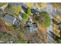 Aerial view of a house nestled among trees in a suburban neighborhood at 201 N Knightsbridge Rd, Cary, NC 27513