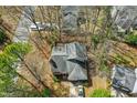 Aerial view of a house with a dark roof surrounded by trees and a driveway at 201 N Knightsbridge Rd, Cary, NC 27513