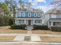 Beautiful blue two-story home featuring a classic front porch and well-maintained landscaping at 2118 Cloud Cover Ln, Raleigh, NC 27614