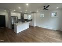 Bright kitchen with stainless appliances, a center island, and sleek hardwood floors at 2214 Woodrow St, Durham, NC 27705