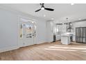 Bright open-concept kitchen with stainless steel appliances, island, and light hardwood floors at 2218 Woodrow St, Durham, NC 27705