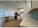 Modern kitchen featuring stainless steel appliances, white cabinets, and granite countertops at 2353 Whitewing Ln, Wendell, NC 27591