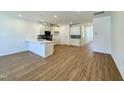 Spacious open-concept living area with wood flooring and plenty of natural light at 2353 Whitewing Ln, Wendell, NC 27591