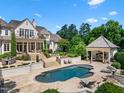 Beautiful backyard featuring a pool, sun loungers, dining and an outdoor bar area, great for entertaining at 266 Perfect Moment Dr, Durham, NC 27713