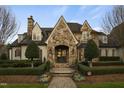 Charming stone home featuring a detailed arched entryway and manicured landscaping at 266 Perfect Moment Dr, Durham, NC 27713